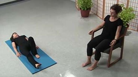 A woman doing yoga on a mat and a woman doing chair yoga.