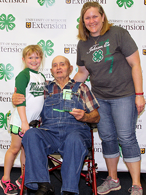 Three generations of 4-H participants pose for a photo.