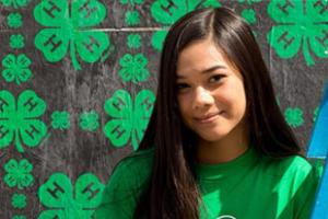 girl in front of 4-H logo background